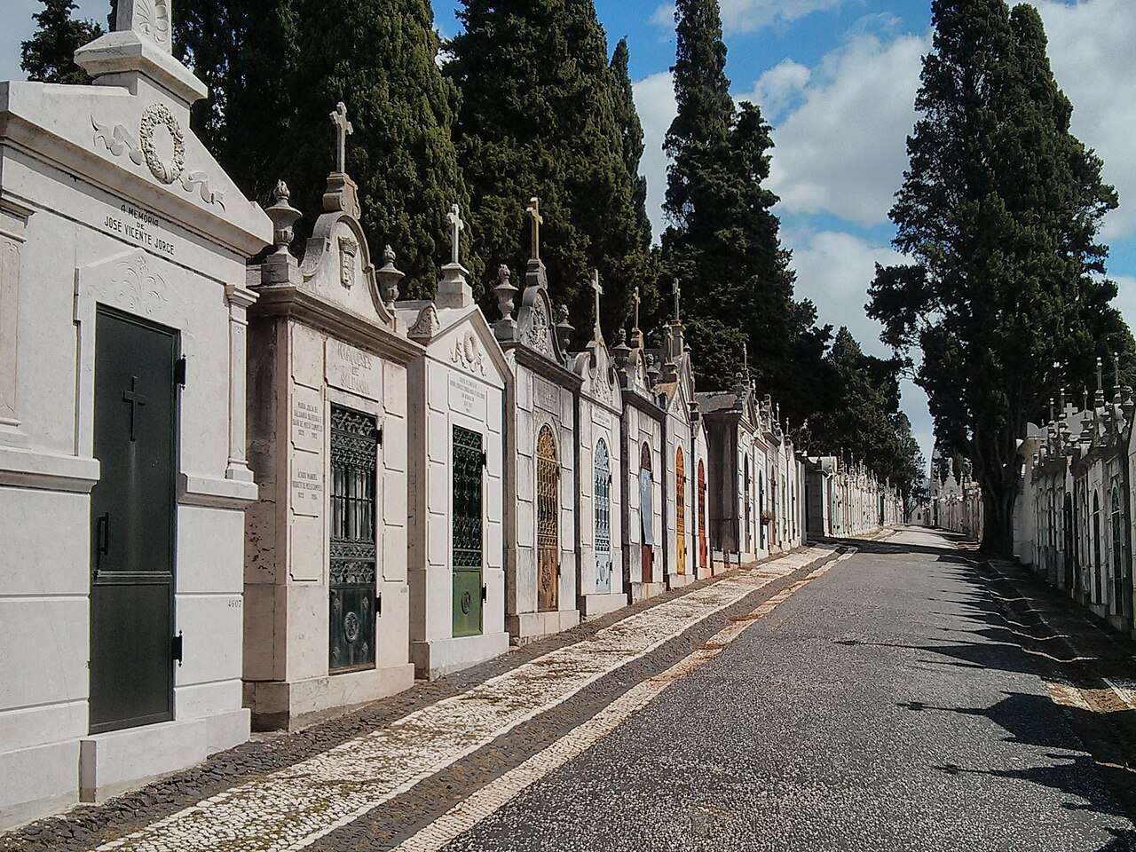 Cemitério dos Prazeres, Lisbon — a street of neoclassical mausoleums.